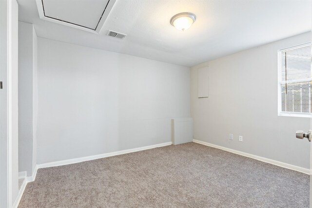 carpeted empty room with visible vents and baseboards