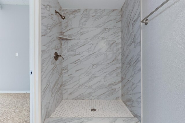 bathroom with a tile shower