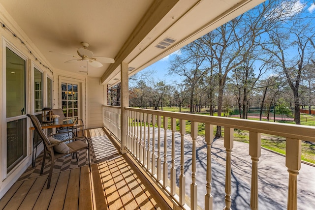 balcony with a ceiling fan and visible vents