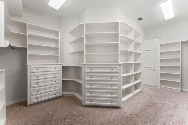 walk in closet with visible vents and dark carpet