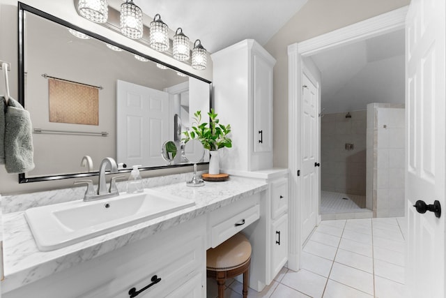 full bathroom featuring tile patterned flooring, tiled shower, vanity, and vaulted ceiling