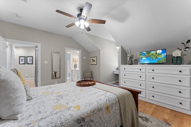 bedroom with baseboards, lofted ceiling, light wood-style flooring, ceiling fan, and ensuite bathroom