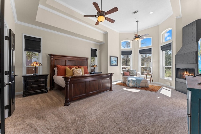 bedroom featuring light carpet, visible vents, a fireplace, and baseboards