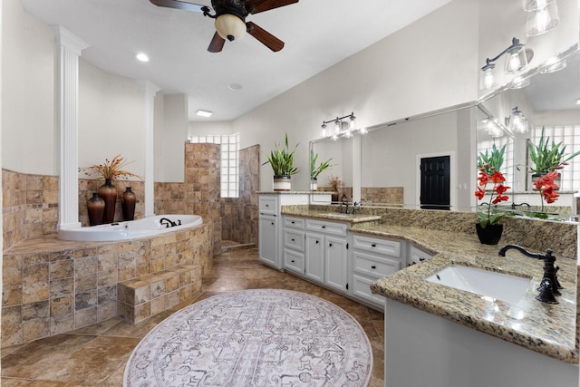 bathroom featuring vanity, a bath, and ceiling fan