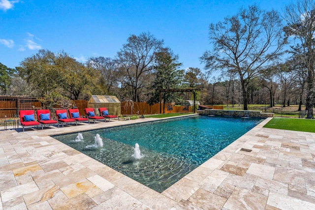 view of pool with a fenced backyard, a fenced in pool, an outdoor structure, and a patio