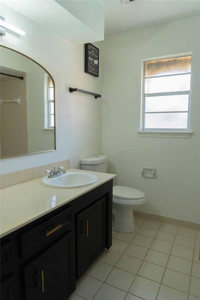 bathroom with vanity, toilet, and tile patterned flooring