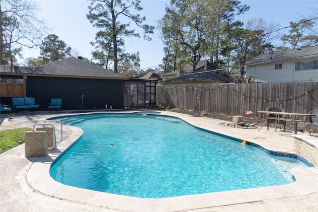 view of swimming pool with a fenced in pool, fence, and a patio area