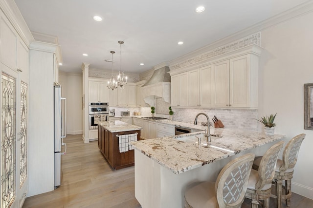 kitchen with custom exhaust hood, appliances with stainless steel finishes, a peninsula, and crown molding