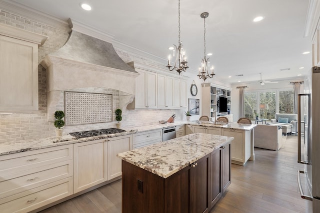 kitchen featuring custom range hood, appliances with stainless steel finishes, crown molding, and a peninsula