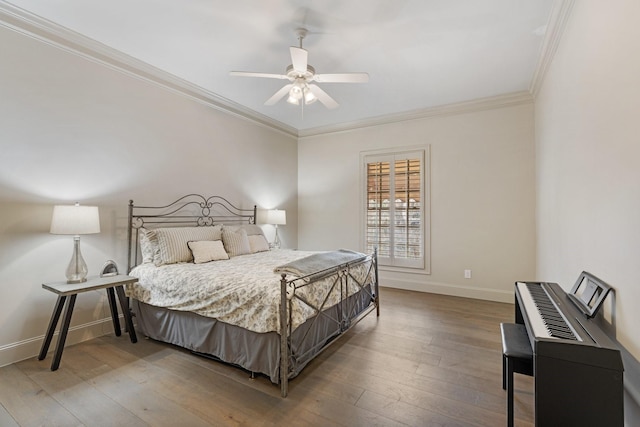 bedroom with ceiling fan, baseboards, hardwood / wood-style floors, and ornamental molding