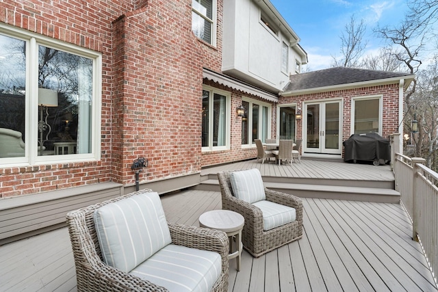 wooden deck featuring grilling area and french doors