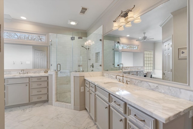 bathroom with visible vents, crown molding, ceiling fan, a stall shower, and a sink