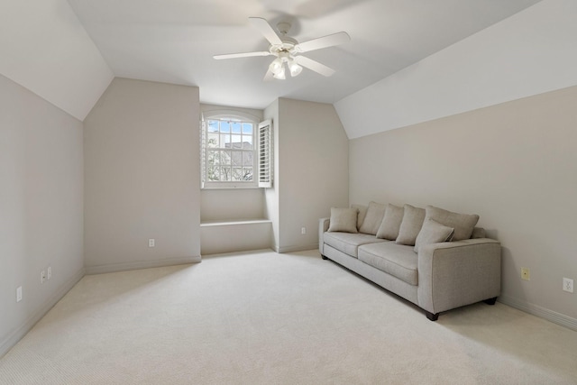 living area with baseboards, carpet, a ceiling fan, and vaulted ceiling