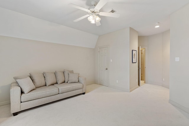 living room featuring visible vents, lofted ceiling, a ceiling fan, baseboards, and light colored carpet