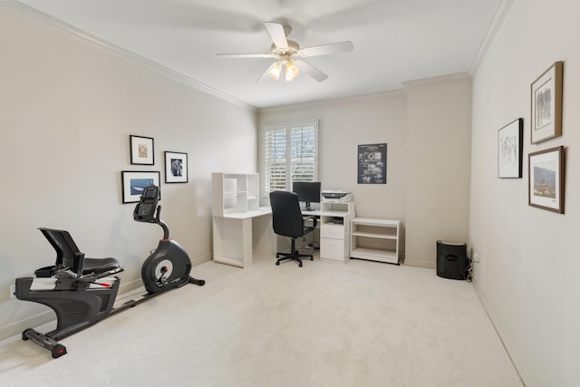 carpeted office space with crown molding, baseboards, and ceiling fan