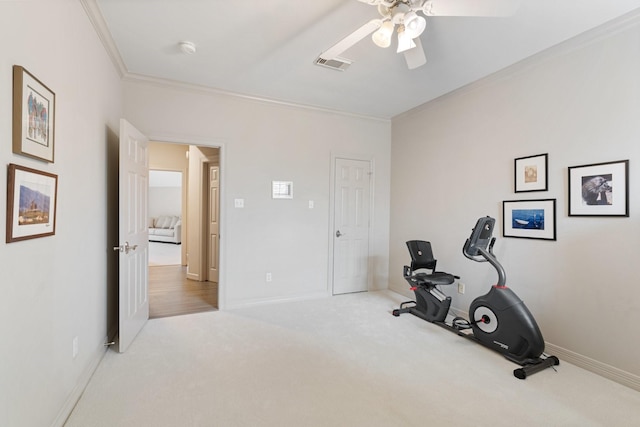 exercise area featuring visible vents, ornamental molding, carpet, baseboards, and ceiling fan