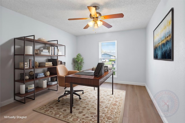 home office with a textured ceiling, wood finished floors, baseboards, and ceiling fan