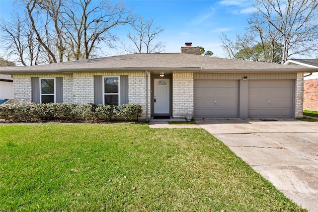 ranch-style home featuring driveway, an attached garage, a chimney, a front lawn, and brick siding