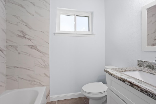 full bath with baseboards, toilet, vanity, and shower / tub combination