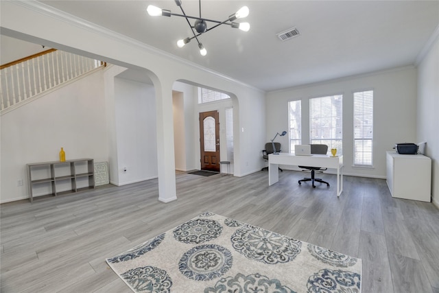 office featuring visible vents, crown molding, wood finished floors, arched walkways, and a notable chandelier