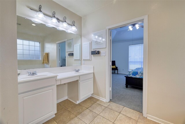 full bathroom featuring double vanity, ensuite bath, baseboards, and a sink