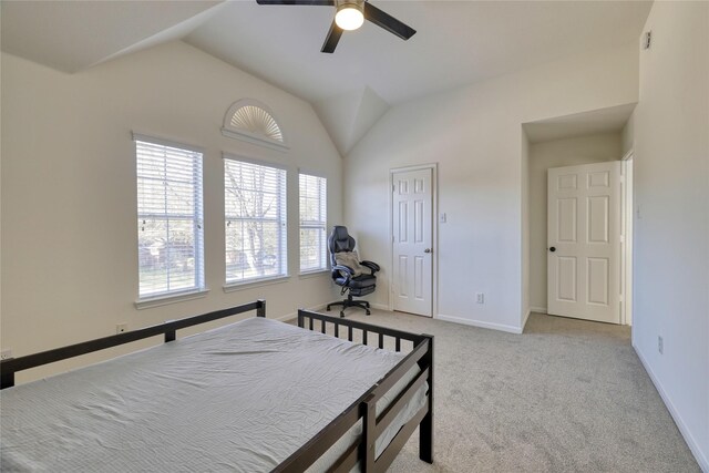 carpeted bedroom featuring lofted ceiling, baseboards, and ceiling fan