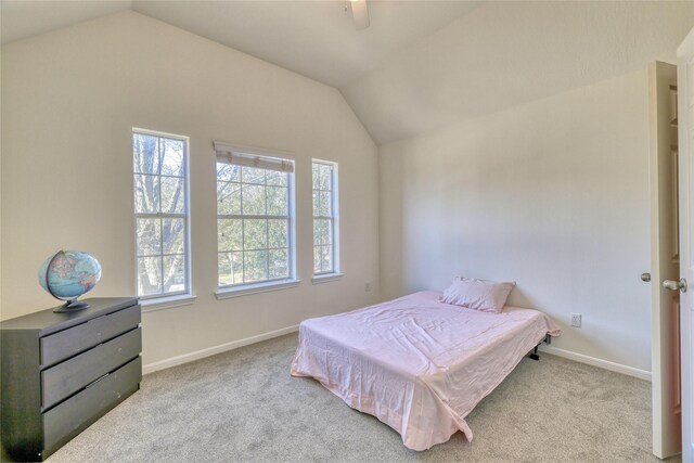 carpeted bedroom with baseboards, lofted ceiling, and ceiling fan