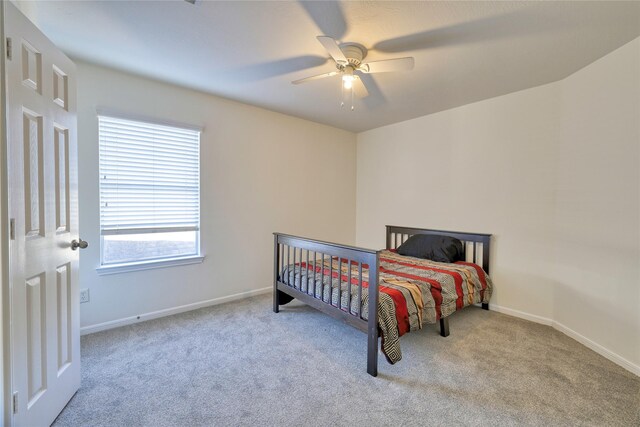 bedroom with carpet flooring, ceiling fan, and baseboards