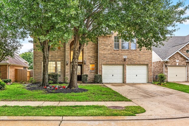 17614 Wind Mist Ln, Cypress, TX 77433 - view of front of property featuring brick siding, driveway, and an attached garage