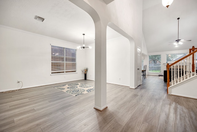 17614 Wind Mist Ln, Cypress, TX 77433 - entryway with arched walkways, light wood-style flooring, a ceiling fan, stairway, and baseboards