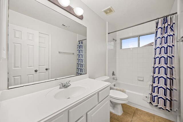 17614 Wind Mist Ln, Cypress, TX 77433 - bathroom with vanity, toilet, shower / tub combo with curtain, and tile patterned flooring