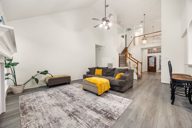 17614 Wind Mist Ln, Cypress, TX 77433 - living area featuring stairway, high vaulted ceiling, a ceiling fan, and wood finished floors