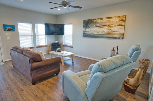 living room featuring ceiling fan, baseboards, wood finished floors, and recessed lighting