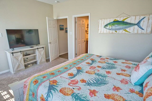 bedroom with carpet flooring and baseboards