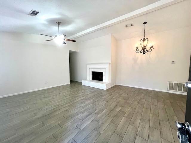 unfurnished living room featuring lofted ceiling with beams, visible vents, and dark wood-style flooring