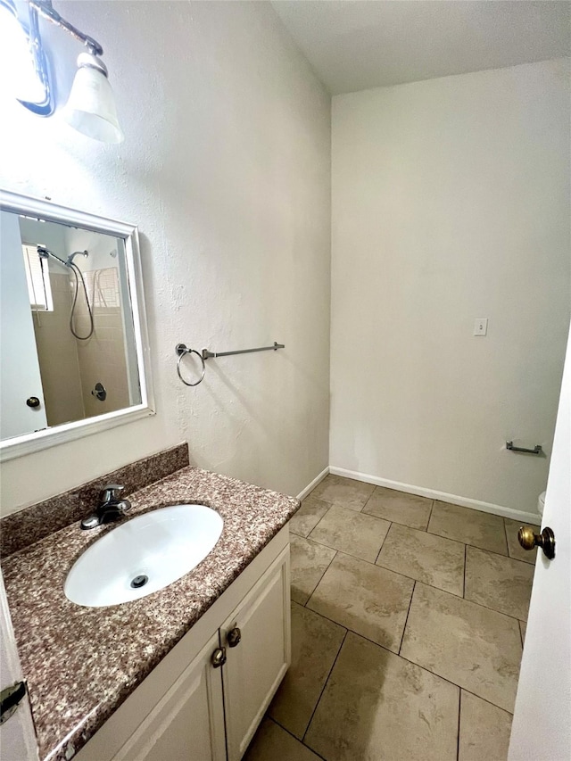 full bath with a shower, baseboards, vanity, and tile patterned flooring