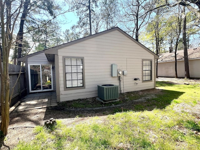 back of house with a yard, central AC, and fence