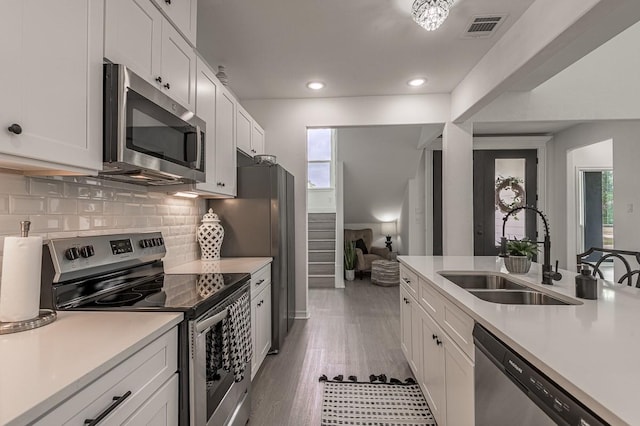 kitchen featuring a sink, visible vents, appliances with stainless steel finishes, and light countertops