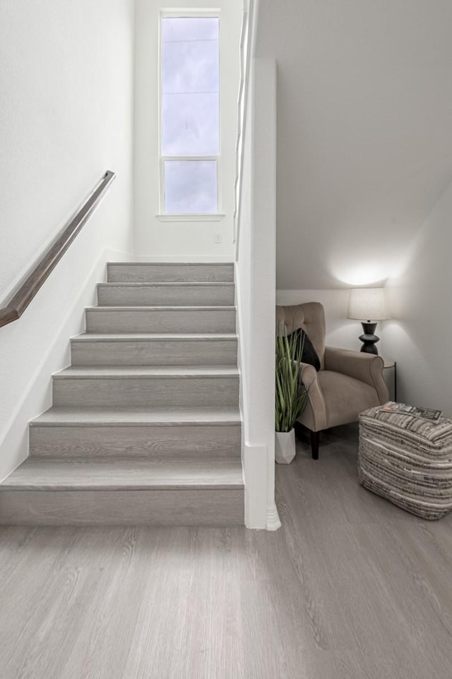 stairway with wood finished floors