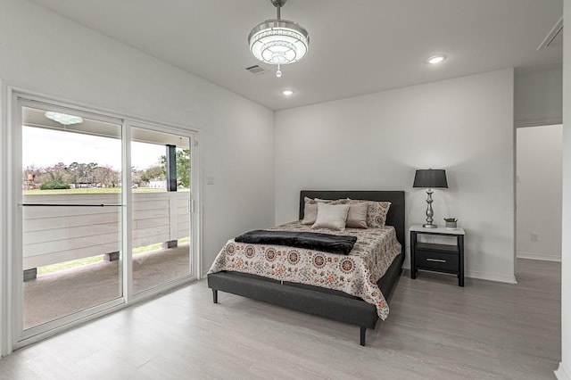 bedroom featuring recessed lighting, baseboards, wood finished floors, and access to exterior