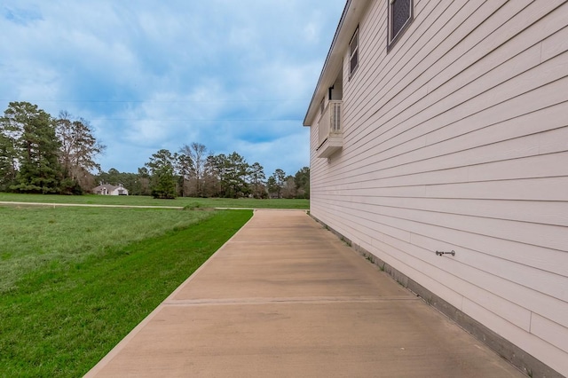 view of side of home featuring a lawn