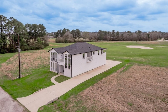 exterior space with cooling unit and a lawn