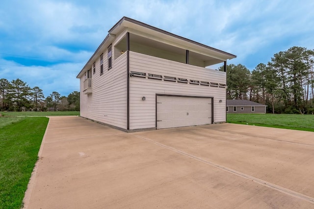 view of home's exterior featuring a yard, an attached garage, and driveway