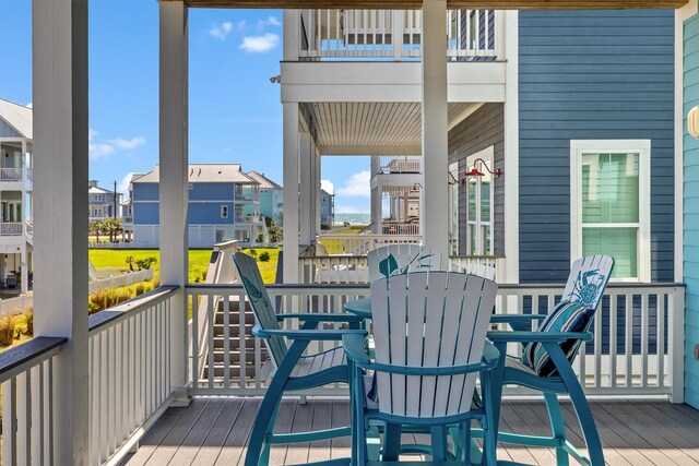 wooden deck featuring outdoor dining area and a residential view