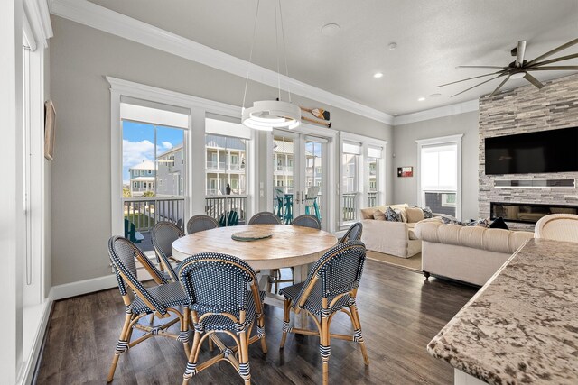 dining space with dark wood-style flooring, baseboards, ceiling fan, and ornamental molding