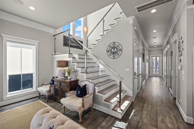 stairway featuring visible vents, ornamental molding, wood finished floors, recessed lighting, and baseboards