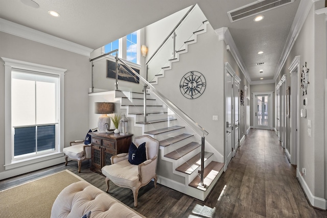 stairway featuring wood finished floors, baseboards, visible vents, recessed lighting, and ornamental molding