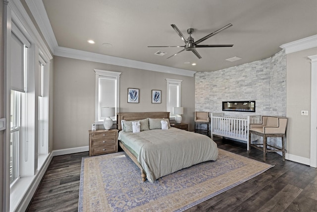 bedroom with baseboards, visible vents, dark wood-style flooring, and ornamental molding