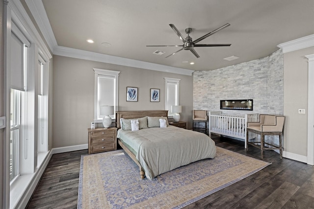 bedroom with visible vents, baseboards, dark wood-type flooring, and crown molding