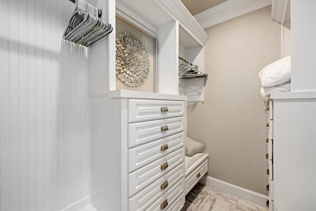 walk in closet with marble finish floor